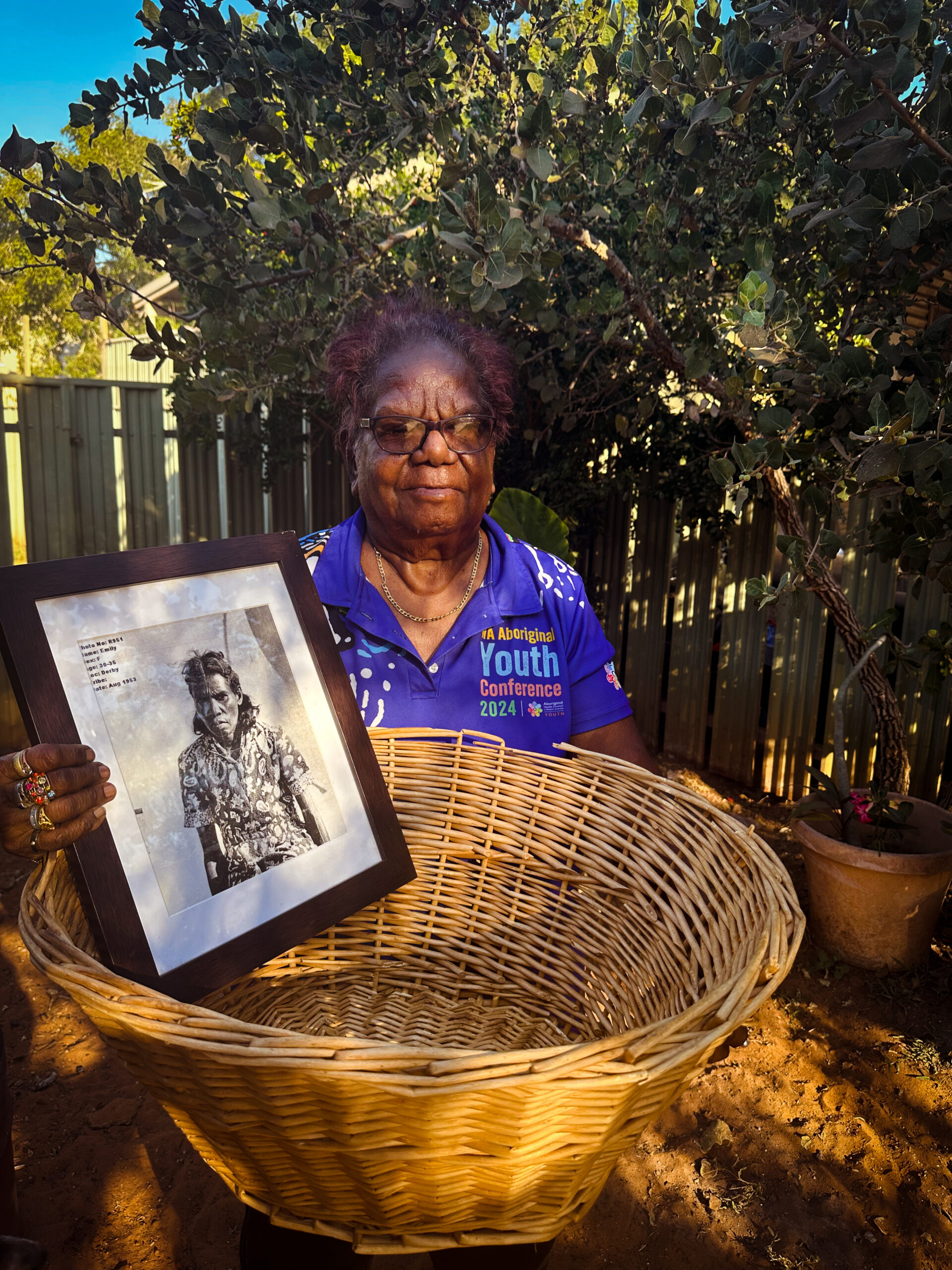 SG © TLMA Kathy Watson_with a basket like the one she was carried in as a child and a picture of her Mum_IMG_0364