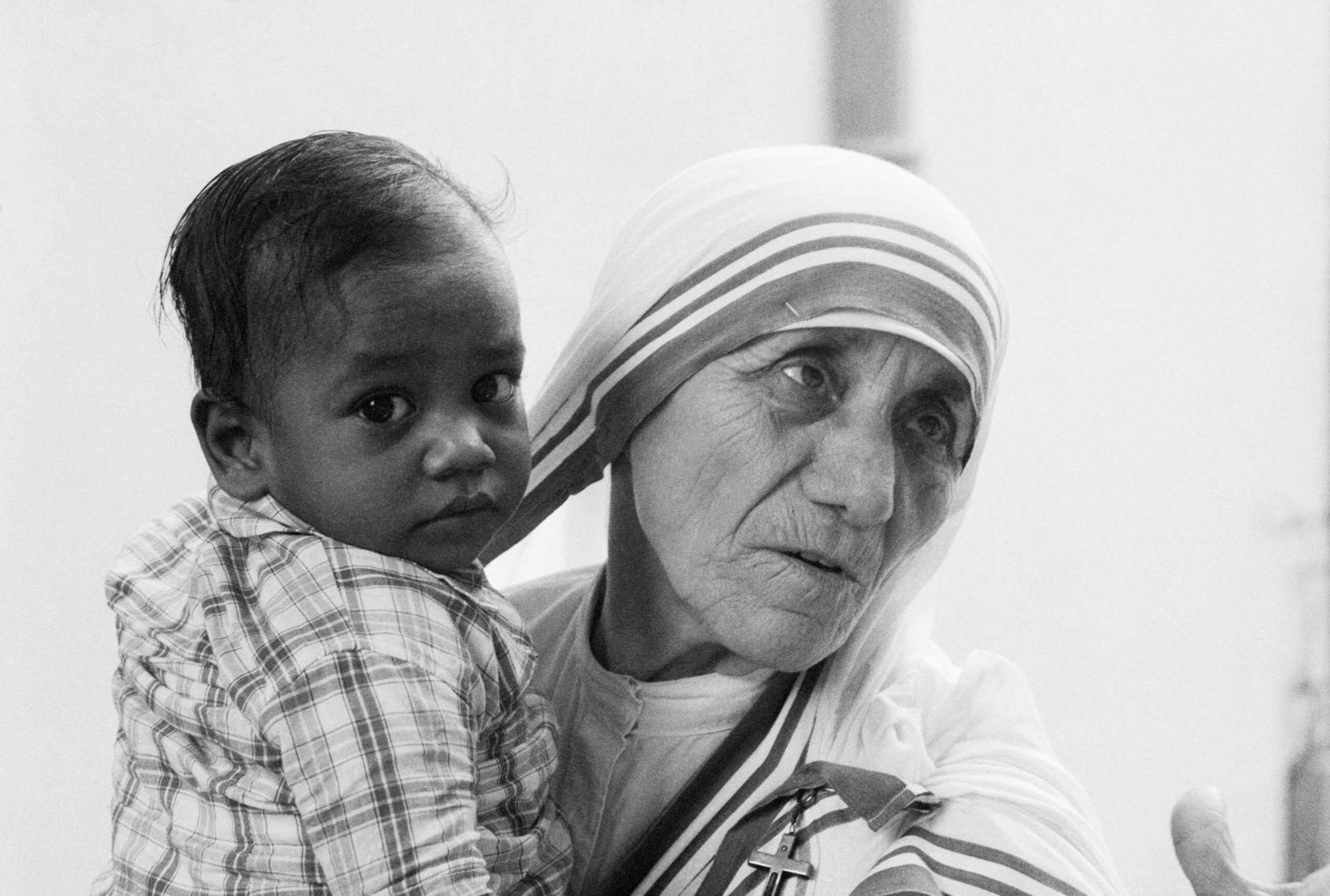 Mother Teresa serving people affected by leprosy through the Missionaries of Charity
