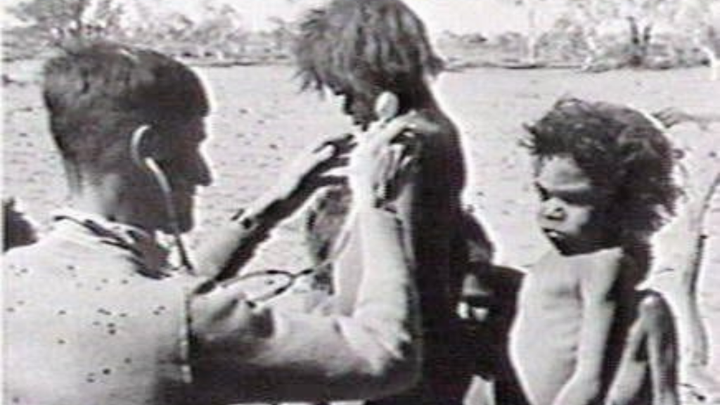 A doctor in a remote clinical setting providing care, representing long-term medical service in underserved areas.