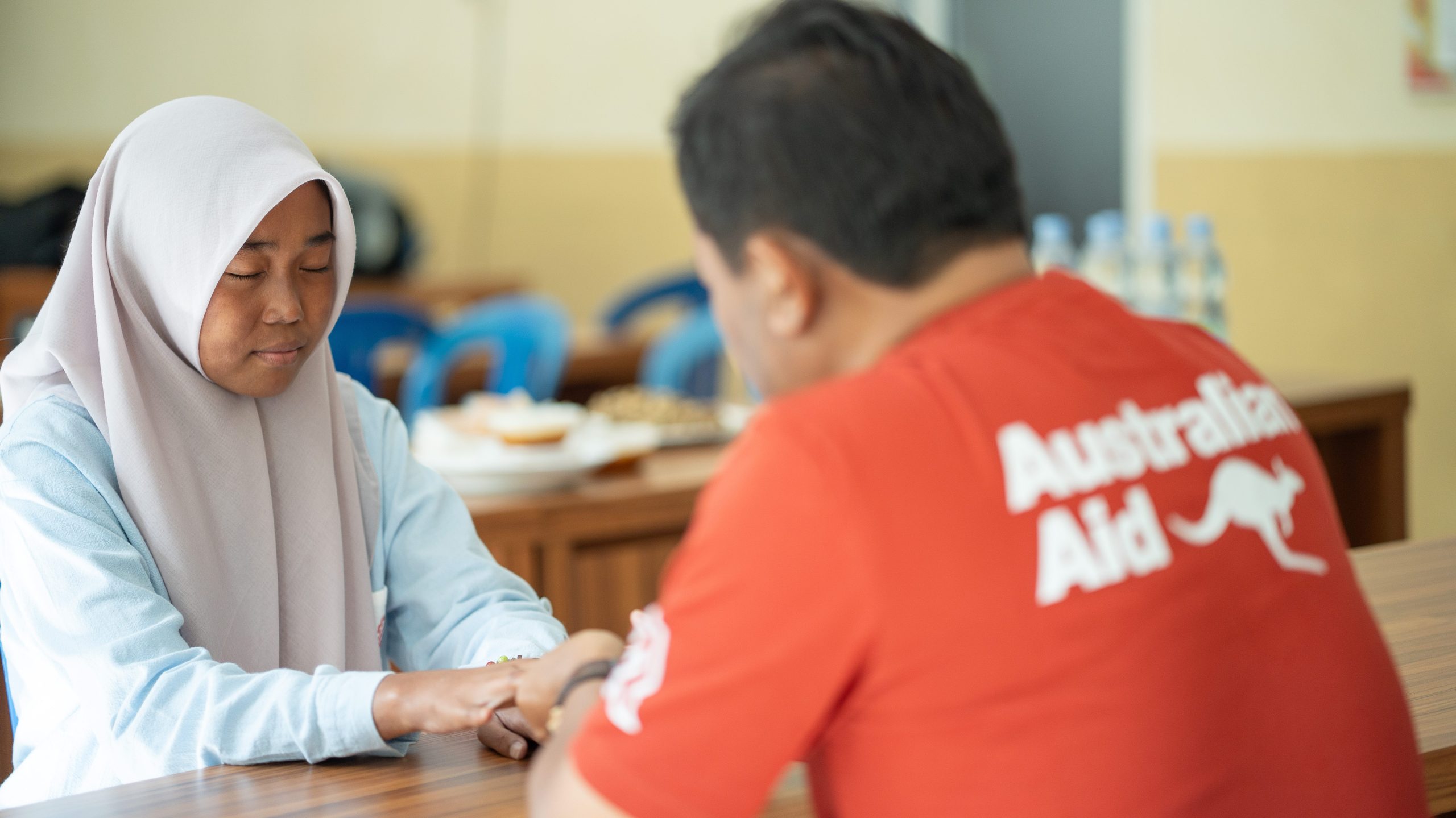 Healthcare workers supported by Australian aid providing medical services