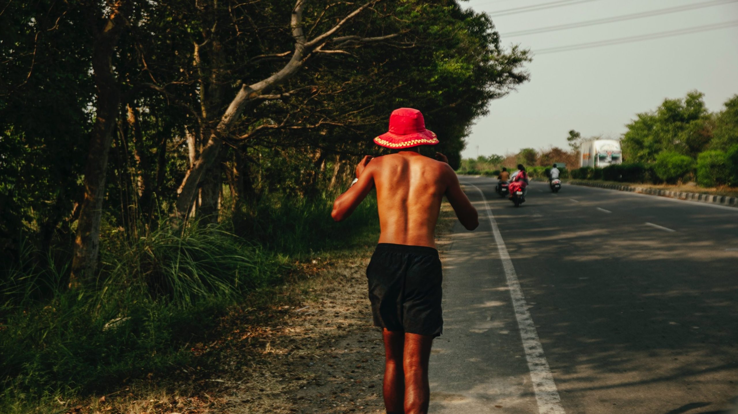 Silhouette of runner on long road at sunset symbolising the One India Run journey