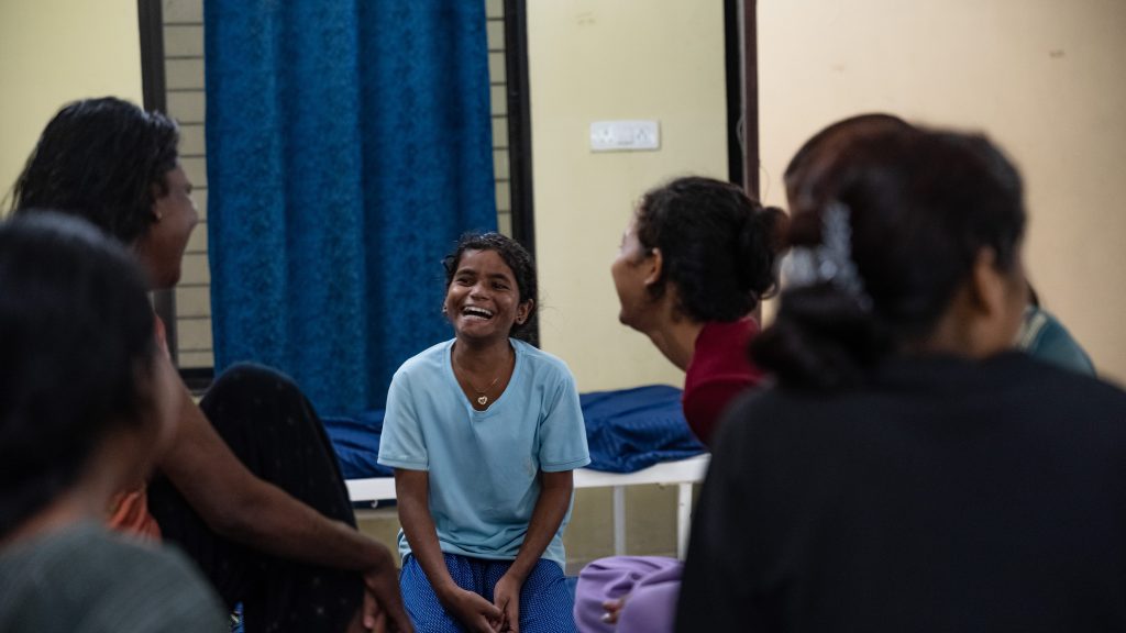 Nisha in the hospital laughing with friends.