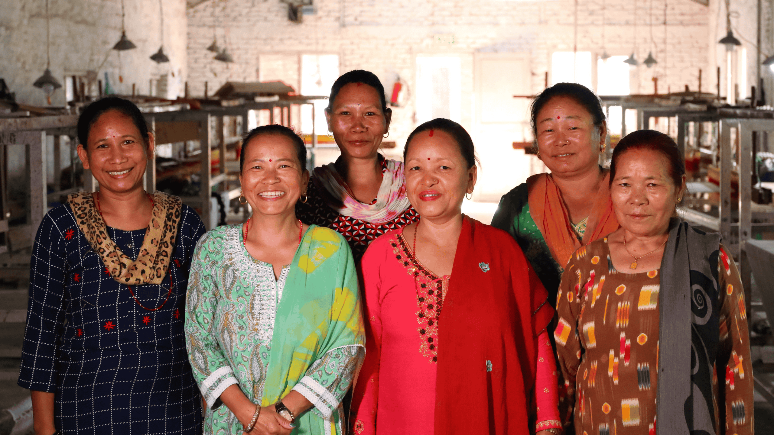 Artisan group working together in a small workshop producing handmade textiles in a fair trade cooperative.