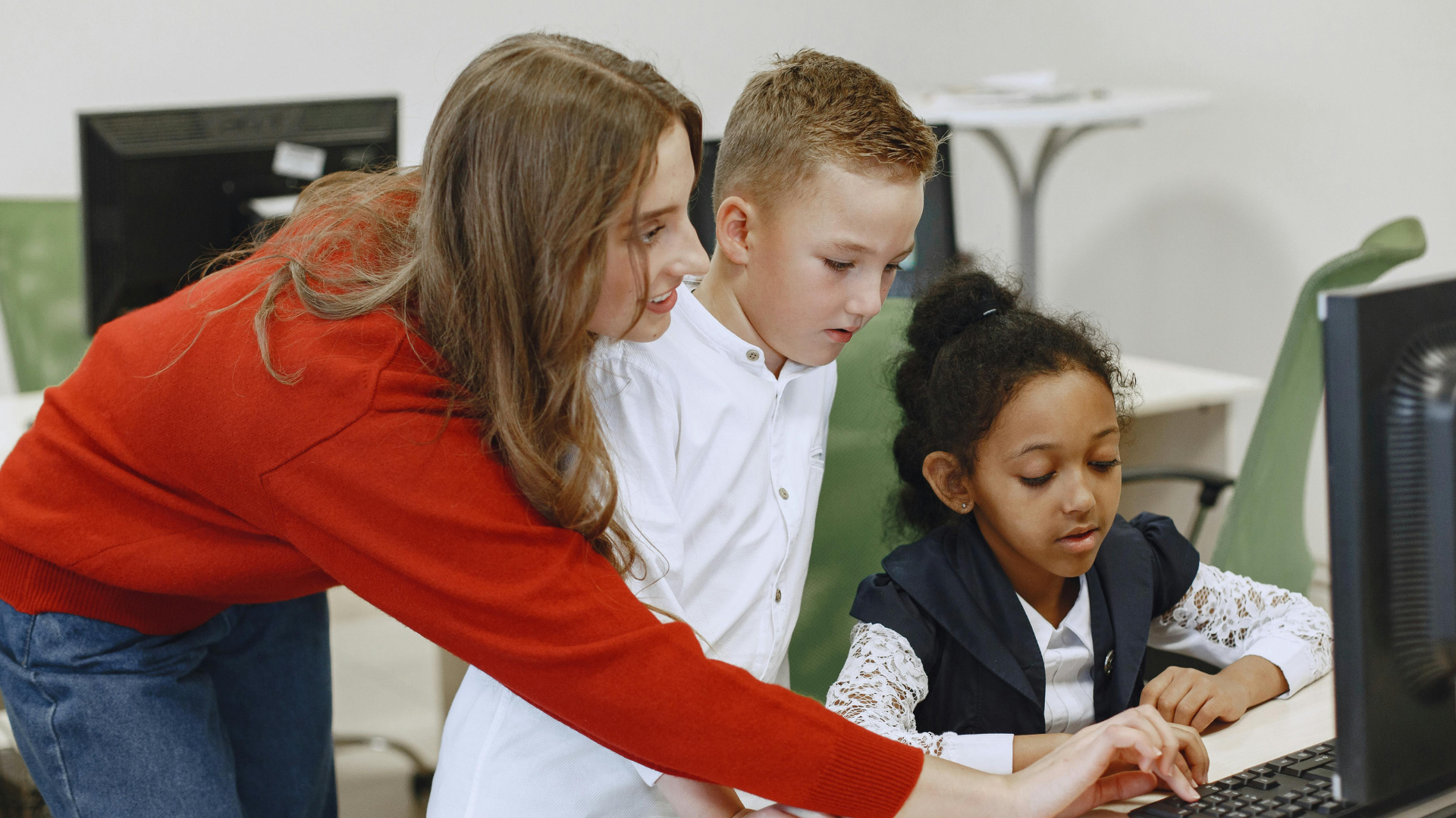 Teacher supporting students with different learning needs in a classroom.