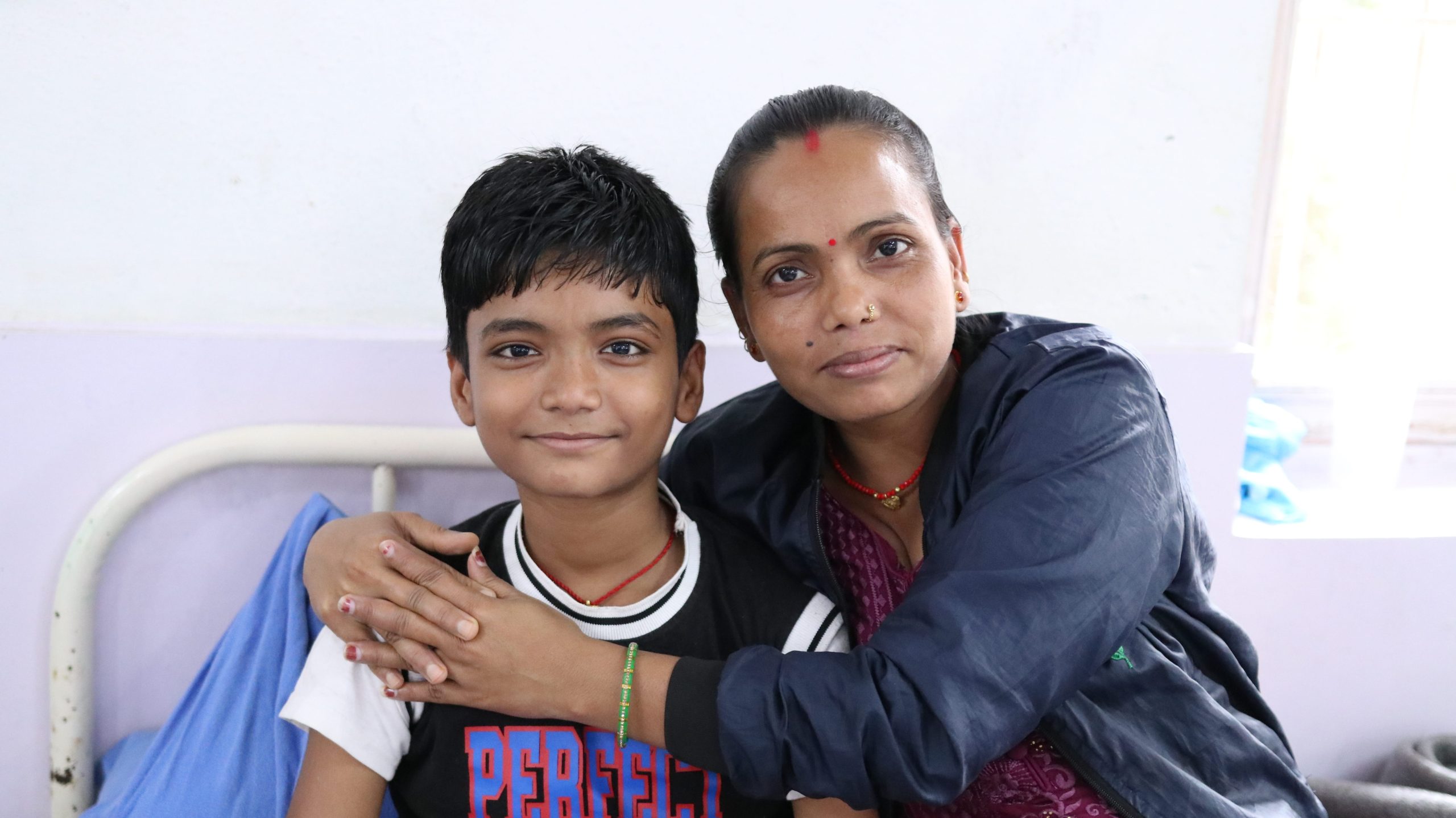 A child smiles after receiving treatment and support for leprosy.